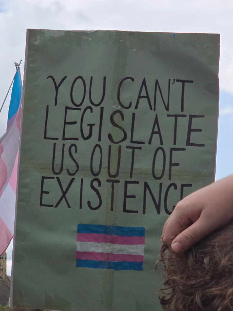 Picture of a sign that says 'you can't legislate us out of existence'