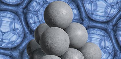 The foreground shows a pyramidal stack of solid, grey spheres. The background shows a magnified image of a Weaire–Phelan structure formed in a foam.