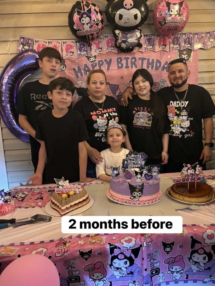 Photo of Karina, her husband, and their four children standing behind a table full of birthday desserts with balloons and Happy Birthday signs behind them