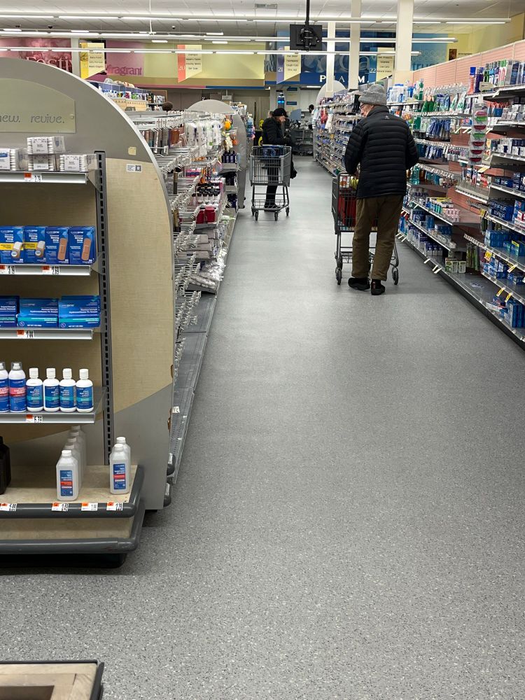 Image of clean grocery store aisle. Sign above says 21.