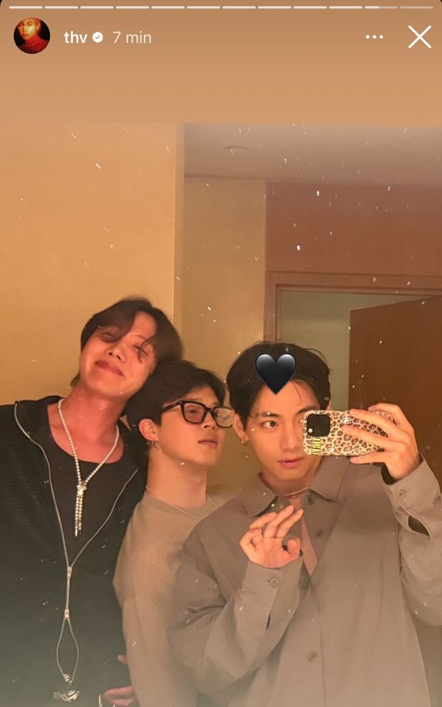 Hobi, Jimin and Tae mirror selca, Hobi is laying his head on Jimin’s shoulder and Tae is cutely waving