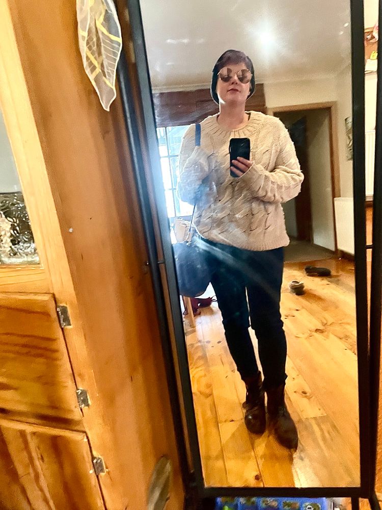 Blaack jeans, cherry brown lace up boots and a cream oversized knit
I have a big bright blue over the shoulder handbag and aviator glasses and a grey beanie