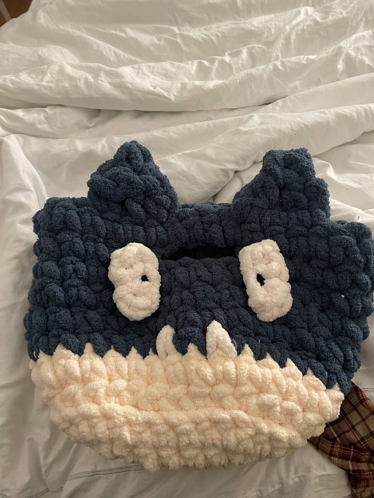 a large crochet bag that resembles the head of the pokémon munchlax