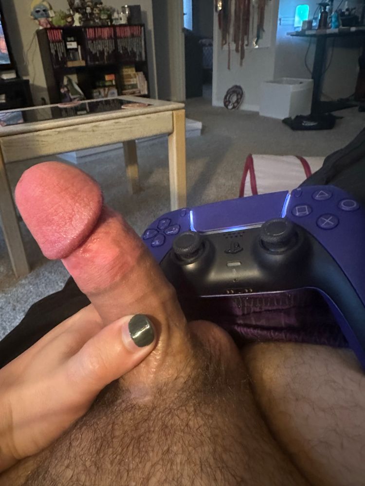 Picture of a hard cock and a purple PlayStation controller 
