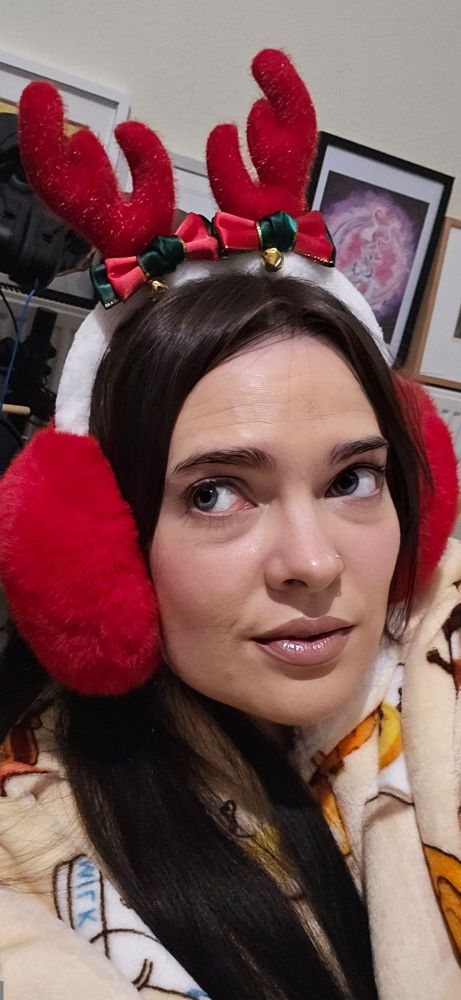 Pippy wears a pair of festive red earmuffs adorned with adorable antlers and green and red ribbons with obligatory bells so EVERYONE can hear she's coming to town!