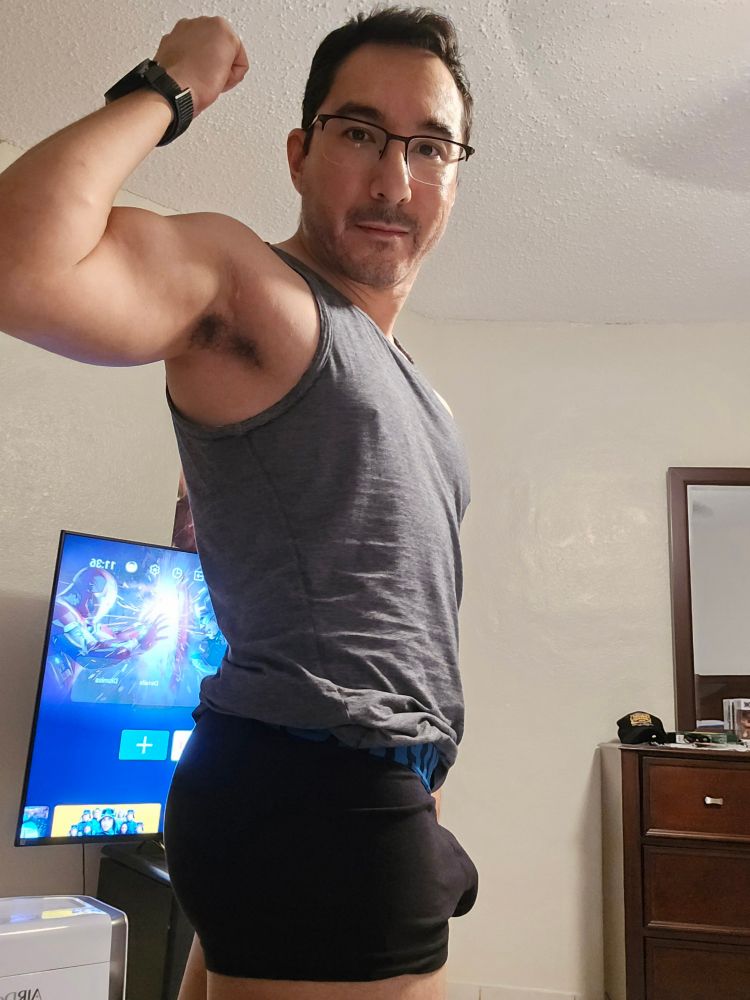 Dork doing some sort of pose and flexing in his undies. 