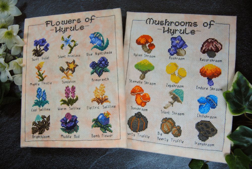 Two brightly colored cross stitch designs stretched on canvas. Flowers of Hyrule, featuring 12 zelda-inspired flowers, and Mushrooms of Hyrule, featuring 12 zelda-inspired mushrooms.