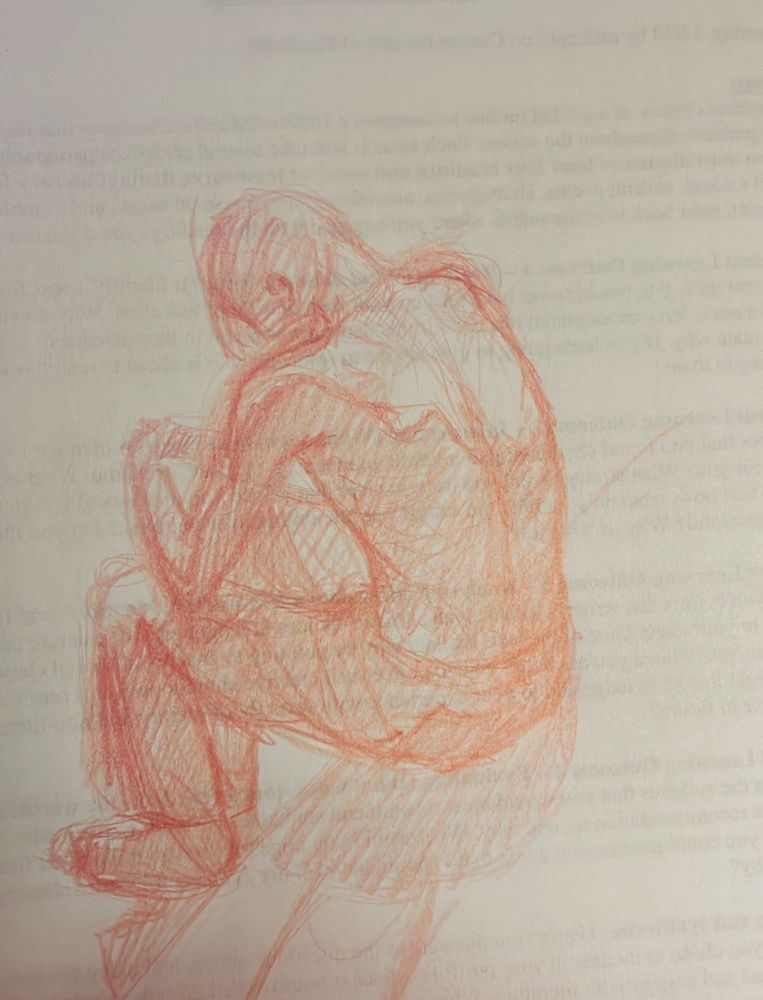 Red pencil on scrap paper drawing or a man sitting hands resting his hands on his legs hunched over himself. 