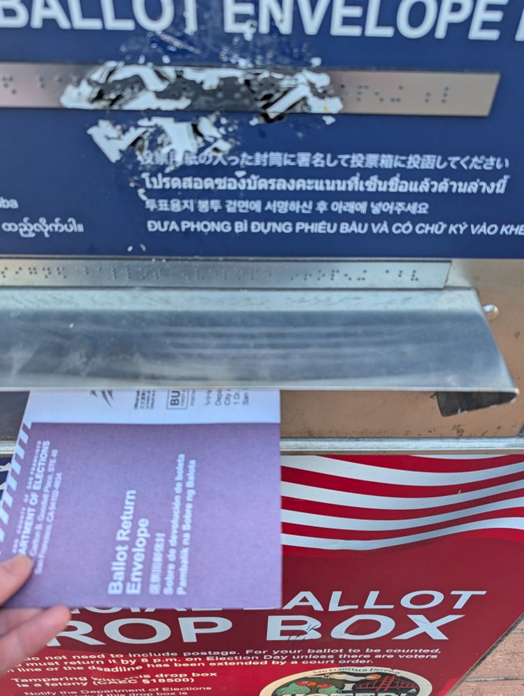 A ballot going in a voting drop box