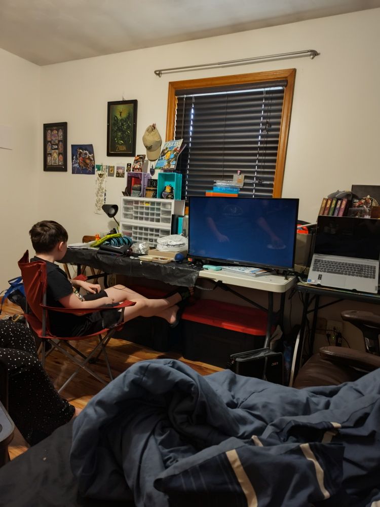 Boy watches documentary on trebuchet at Stirling Castle.