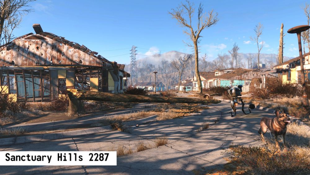 A screenshot showing a fictional neighborhood called "Sanctuary Hills" in the video game Fallout 4. It shows the aftermath of a nuclear war with once prestine neighborhoods now in ruins with Dogmeat the dog visible in the lower left of the screen. Text reads:

"Sanctuary Hills 2287" 
