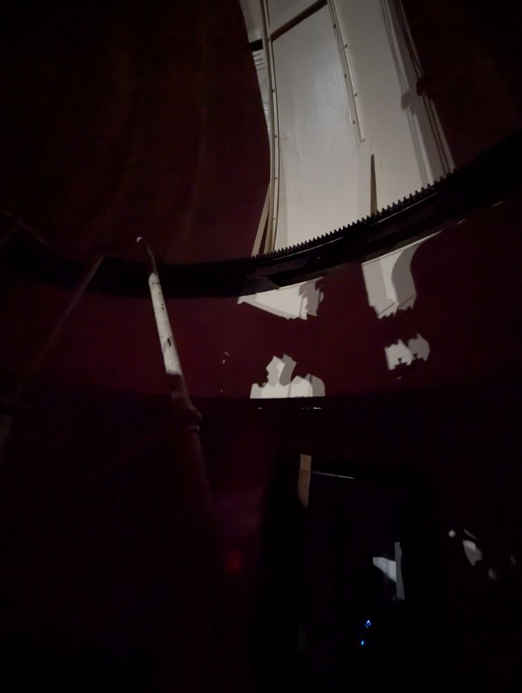 The light from the spotlight, illuminating the wall through the opening in the dome.