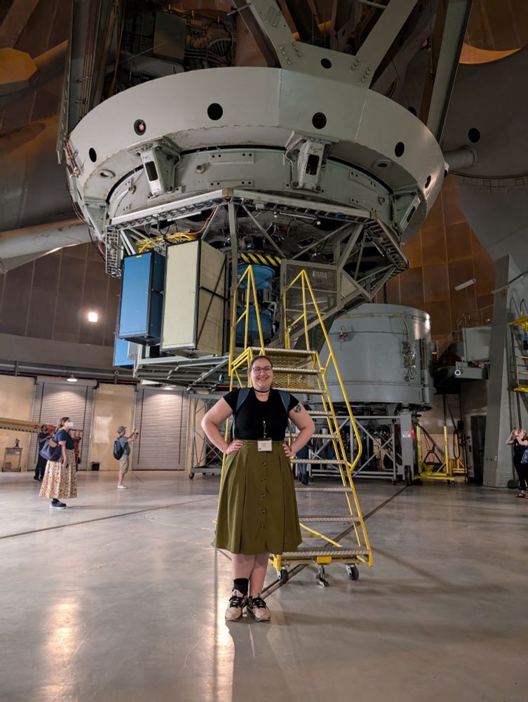 A photo of me standing in front of the 200-inch Hale Telescope at the Mt. Palomar Observatory. All that is visible of the telescope is the cage at the primary focus. Taken during a tour excursion for Cool Stars 22 (astronomy conference).