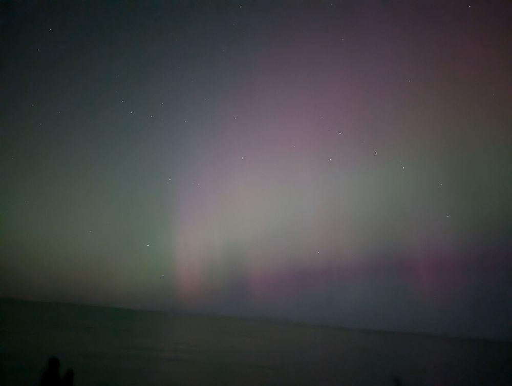 Northern lights, somewhat faint. Red, green, and purple light visible