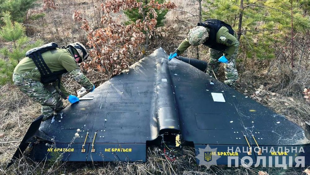 similar drone on the ground captured in Vinnitsa by Ukrainian armed forces with two soldiers examining it