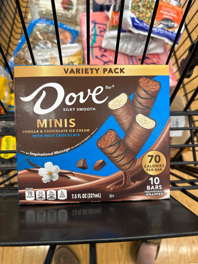 A box of Dove Minis ice cream bars, perched in a shopping cart. 
