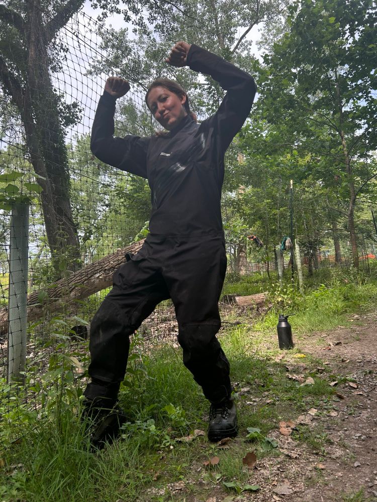 myself with arms up posing for photo in black drysuit