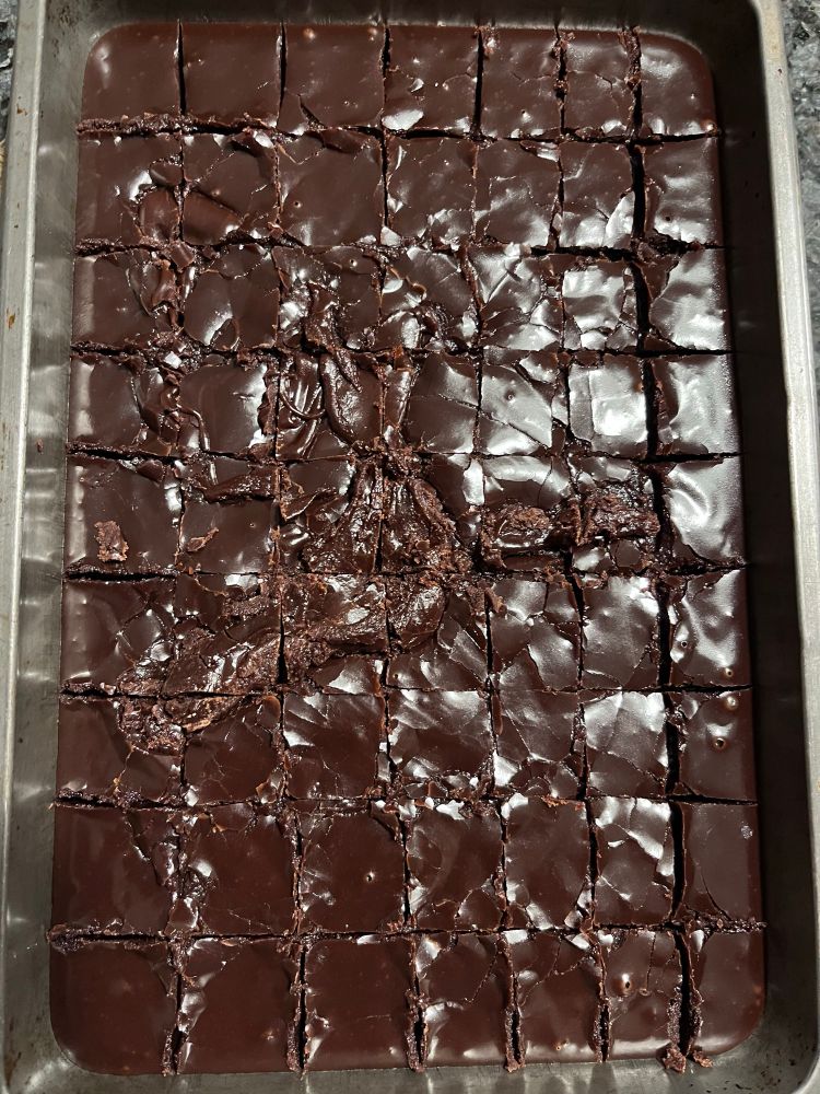 Freshly made chocolate fudge, still warm in a tin