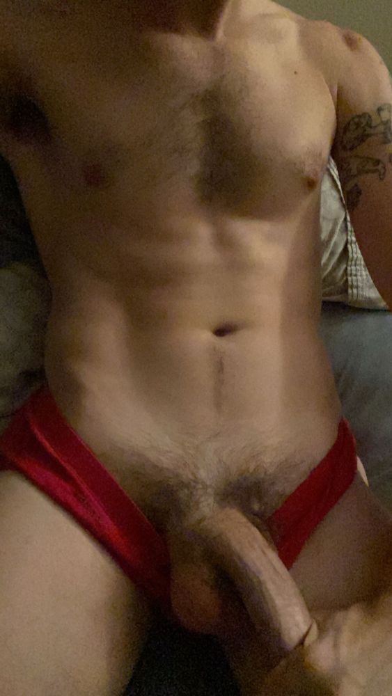 torso & crotch shot of Gray, his underwear is pulled down slightly showing bush & a long thick shaft with his fist grabbing the head.