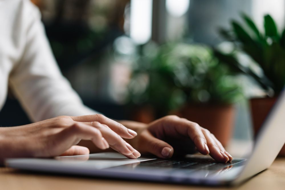 Closeup picture of hands typing on laptop