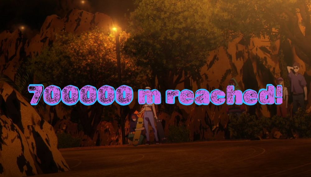 text: 700,000m reached!
image: bystanders watching along the S route