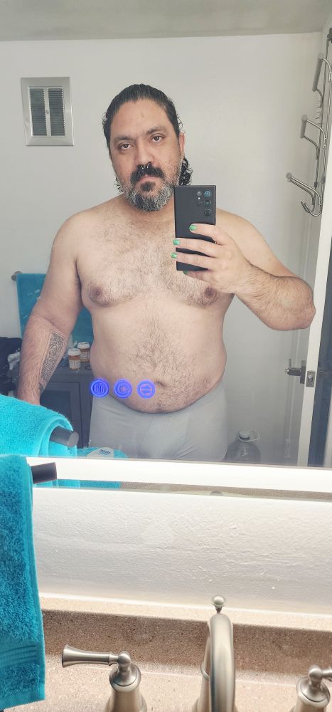 Over standing shirtless in front of a mirror selfie