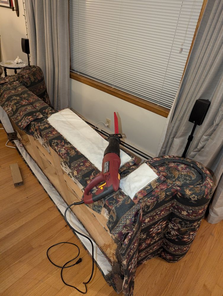 Step 0, Prep, remove covers, cushions, feetsies, and make sure the reciprocating saw blade is plenty big enough to get in there & rated to handle the occasional nail, just in case.  The picture is a couch lying on its back with a reciprocating saw on it.
