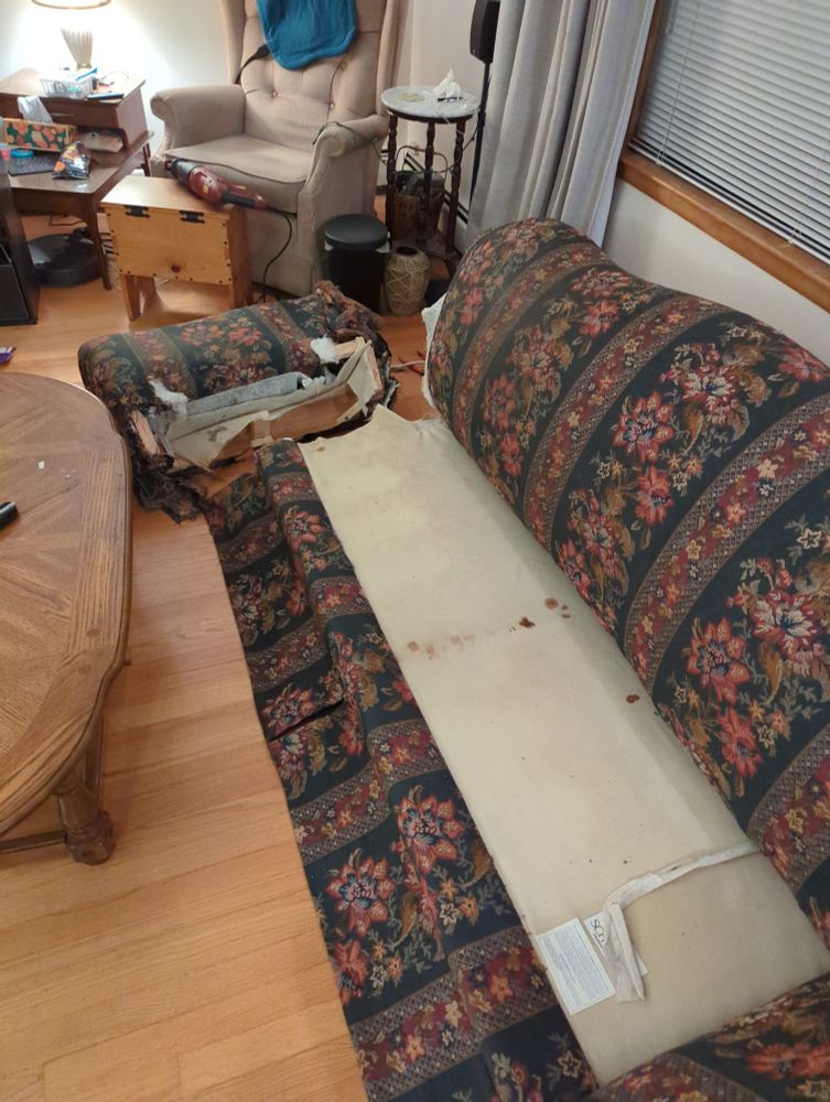 First arm removed from the couch, it's having a little lie down.  It's been on its feet for decades...