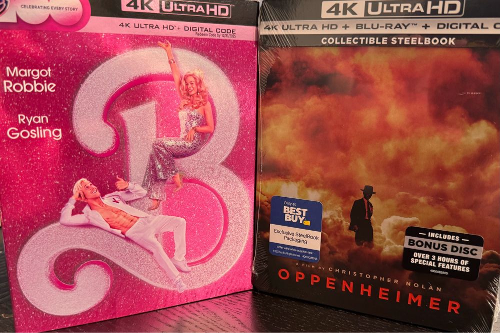 A photo of the covers of the 4K ultra HD releases of the movies Barbie and Oppenheimer.