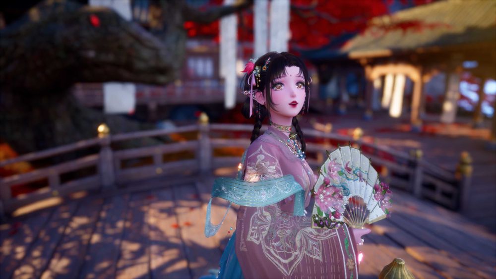 The image is of a young woman on a bridge, holding a white floral fan in her right hand with a look of awe on her face. In the background is a red maple tree with scrolls hanging from its branches, and a temple's pavilion with more hanging scrolls. The woman has braided brown hair with silver floral hair decorations and light pink ribbons in it. She has golden coloured eyes, red painted lips, and a hongdian ("red dot") between her brows. On her ears is silver jewelry to look like elf ears, with red floral decorations and gems hanging from them. She is wearing a golden wired necklace, decorated with several jewels, that has what looks to be a cat's bell on it. Her outfit is light pink with light gold woven into the sleeves in the shape of flowers, a blue floating wrap wrapped around her. She is looking to the viewer's upper right.