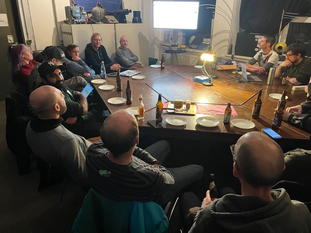 Round of developers gathered at a large table discussing Drupal CMS