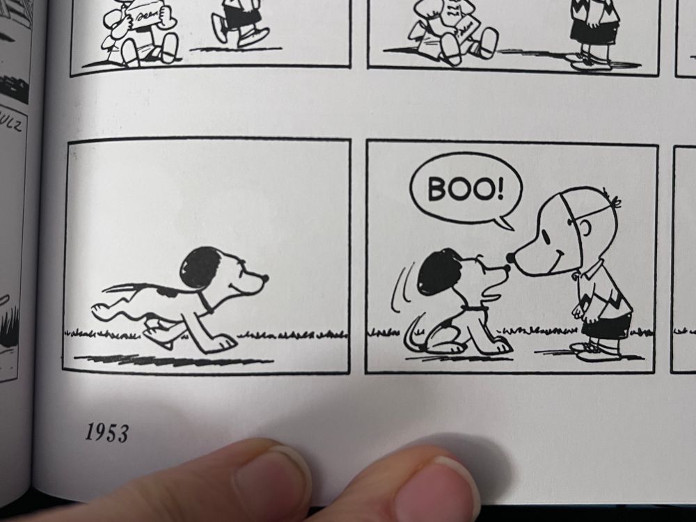 First two panels of 1953 Peanuts, Snoopy is scared by Charlie Brown in a Snoopy mask