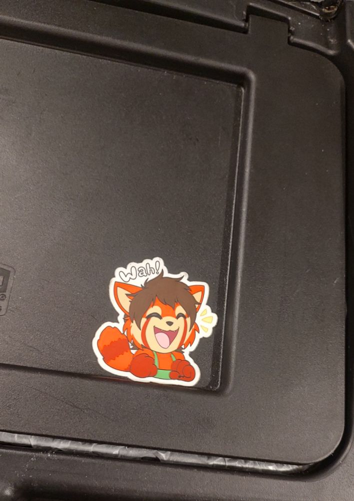 A picture of Token the red panda saying wah! Sticker place on a work cart