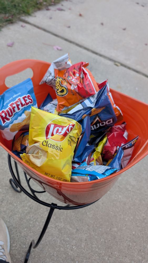 Tub of assorted chips and rice krispies treats