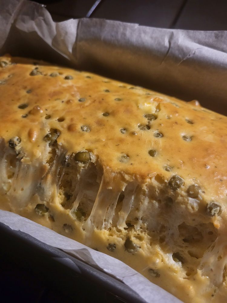 a cake salé with peas and a lot of cheese. it cracked and created a glorious cheese pull