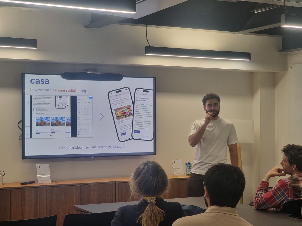 Rowan holding the microphone with a slide titled Casa