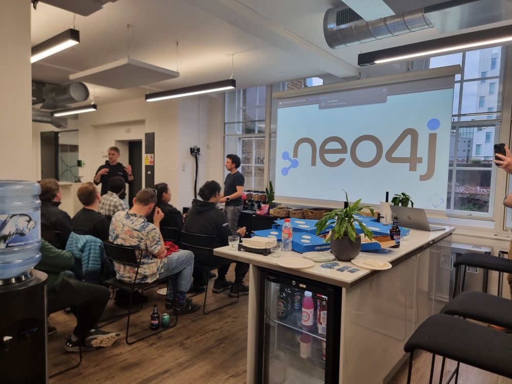 The crowd of Svelte London with a screen saying Neo4j