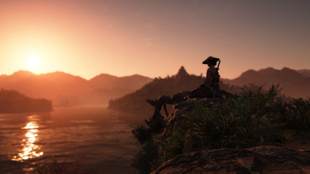 Naoe looking out over the sunset lit waters in Assassins Creed Shadows