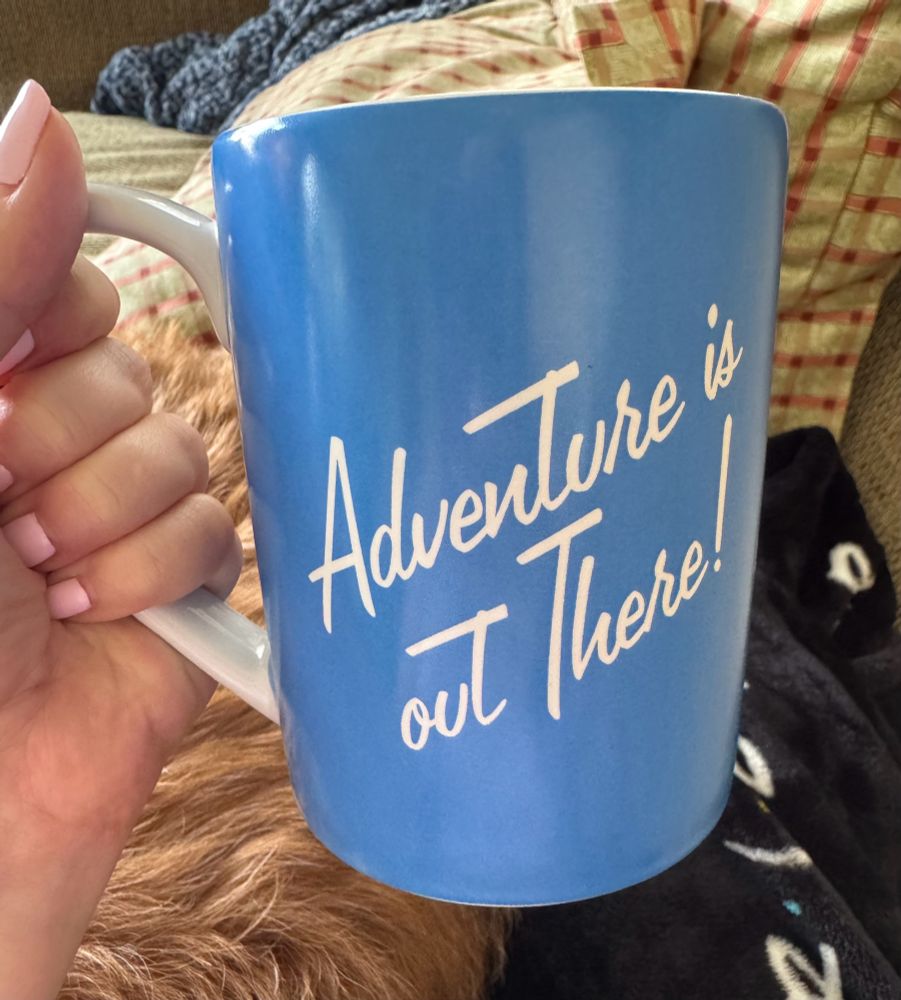 The other side is the quote “Adventure is out there!” against the blue sky.