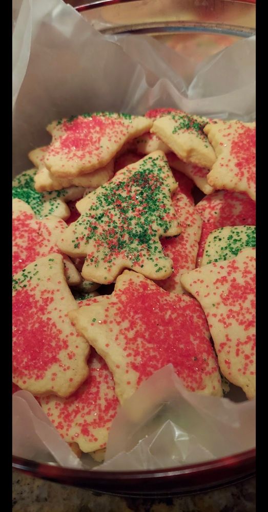 Chrisrmas cookies of stars, trees and bells sprinkled red and green