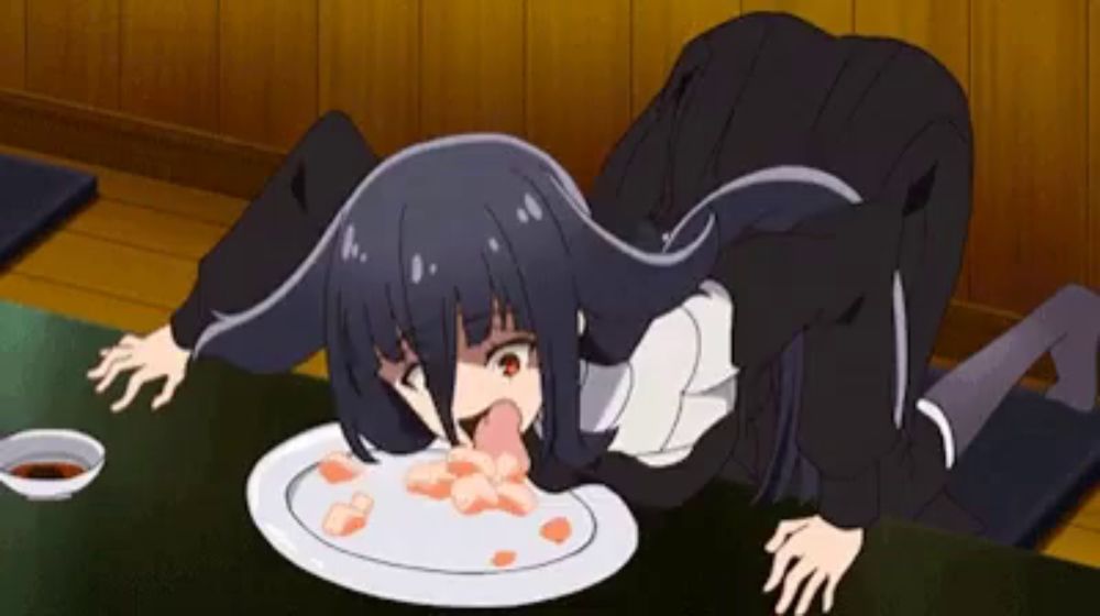 a girl is eating a plate of food with her tongue sticking out