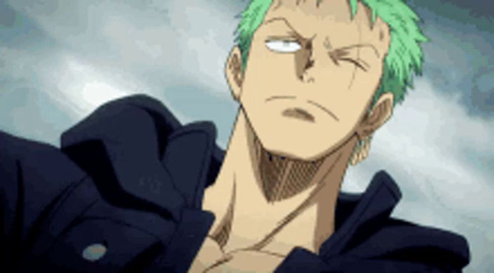 a man with green hair is wearing a black jacket and has his eyes closed .