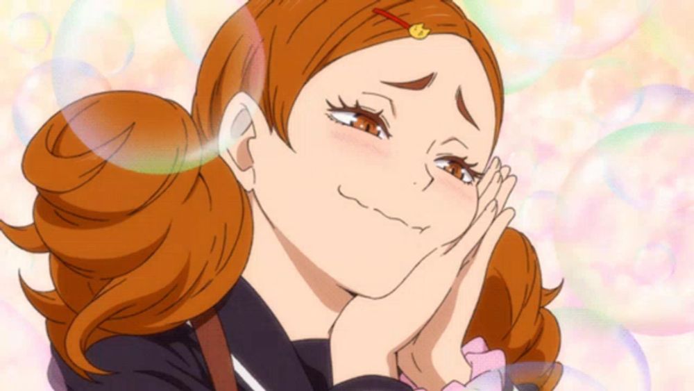 a girl with red hair is making a funny face with her hands on her face