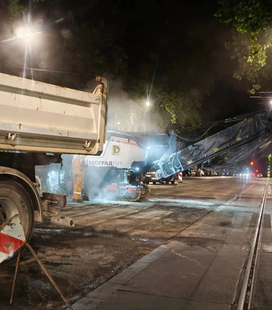 Heavy machinery removing asphalt where pedestrian crosings are present