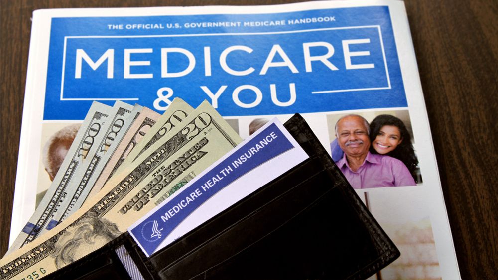Medicare & You handbook with a wallet containing US cash and a Medicare card