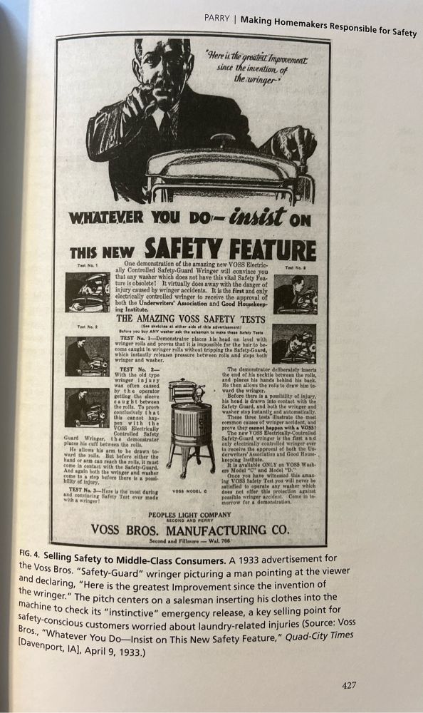 A 1933 advertisement for Voss Bros. “Safety-Guard” wringer picturing a man pointing at the viewer and declaring, “Here is the greatest Improvement since the invention of the wringer.” The pitch centers on a salesman inserting his clothes and hair into the machine to check its “instinctive” emergency release, a key selling point for safety-conscious customers.