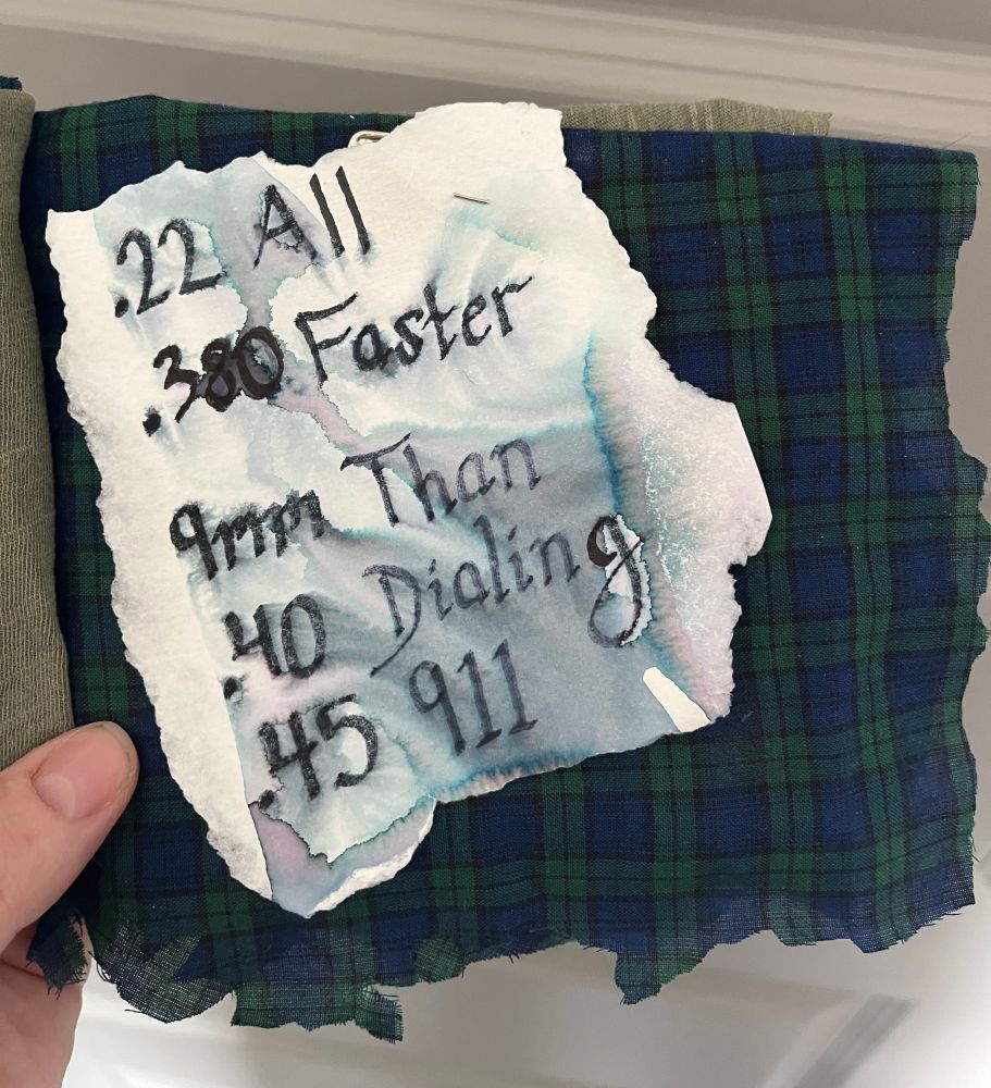 Page 3 of my zine. Blue and green plaid background. Words read (TW GUNS)

.22 All
.380 Faster
9mm Than
.40 Dialing
.45 911