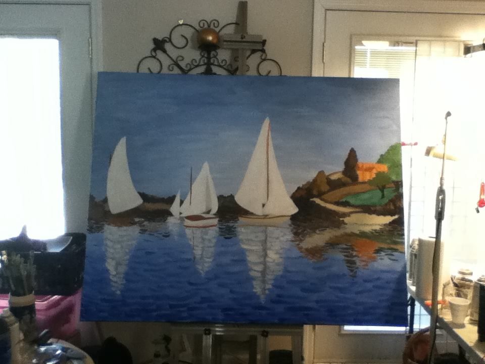 An almost completed painting of 4 sailboats on a calm blue water. They're floating before a rocky cove that leads to colorful hills, with a chateau in the background. 