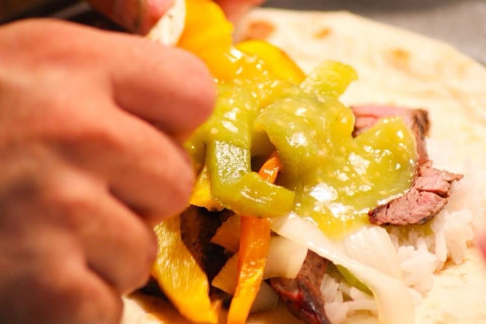 Hands roll a fajita