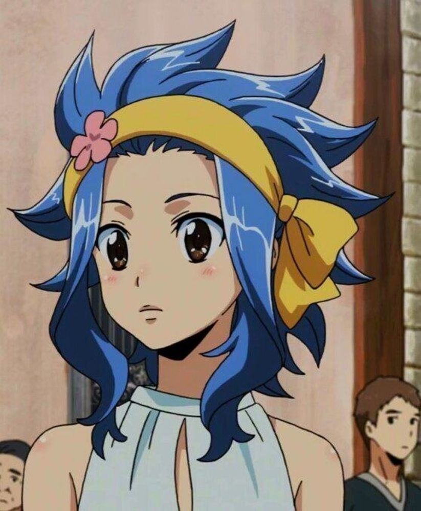 anime girl with soft, medium blue hair, most of it pulled back with a cloth headband so it looks spiky; with longer, slightly curly pieces framing her face. the headband is yellow, and has a little pink flower on the right side.